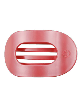 a light pearly coral colored flat round teleties hair clip
