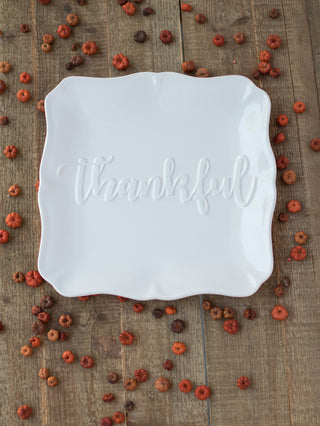 a cream serving plate with thankful embossed across the center perfect for thanksgiving and fall decor