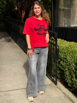a boxy vibrant red georgia bulldogs game day top with black glittered letters worn with faded black jeans