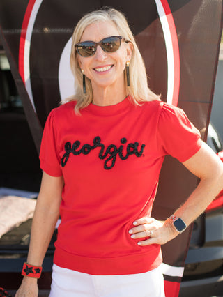 a red sweater tshirt with black glitter text that reads georgia perfect for uga bulldogs football fans
