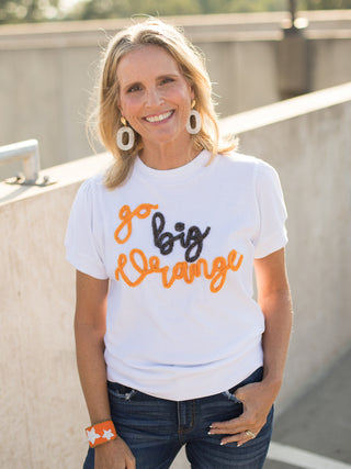 a white sweater tshirt with orange and black glitter text that reads go big orange perfect for tennessee football fans