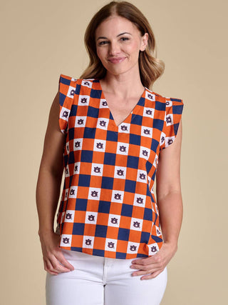 an orange and navy checkered v neck top with the auburn logo