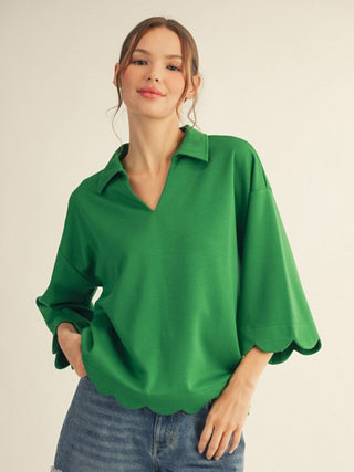 a relaxed green scalloped top with a v neck collar and half sleeves