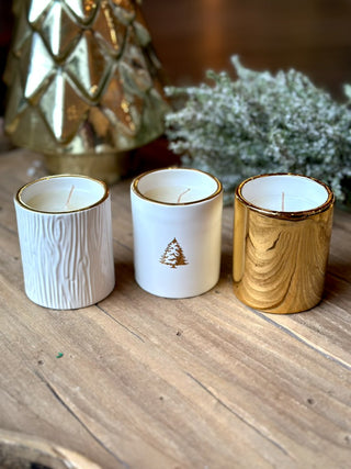 a set of three mini white and gold holiday candles