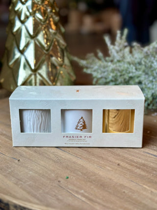 a set of three mini white and gold holiday candles