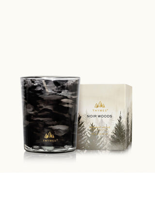 noir woods black smoky candle with wood crisp evergreen and glowing amber vibes