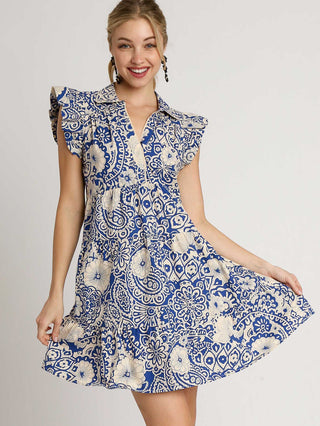 a babydoll style dress in cobalt blue floral print that has a fun flair