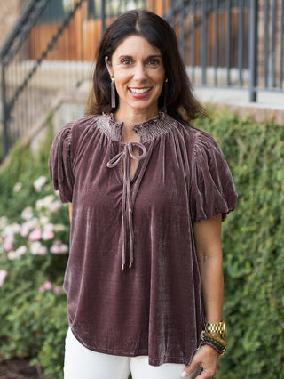 a dark purple velvet top with puff sleeves and feminine ruffles perfect for feminine fall fashion