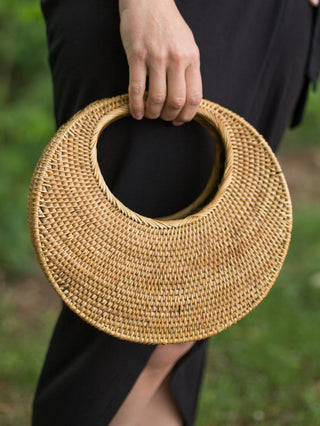 handcrafted balinese round basket purse made of woven ata vine in crescent moon shape with golden color and smoke cured