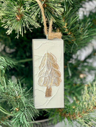 a painted white wooden plaque ornament with an christmas tree image
