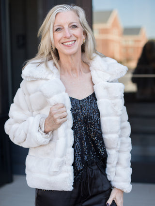 wear this white faux fur coat with luxurious detail for a glamorous outfit to festive holiday parties and family photoshoots