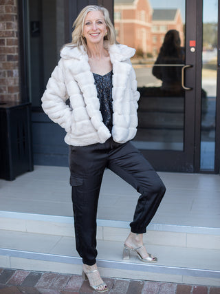 wear this white faux fur coat with luxurious detail for a glamorous outfit to festive holiday parties with a glitter top