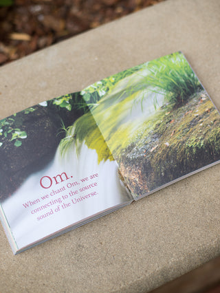 an inspiring quote within the yoga book set against a waterfall