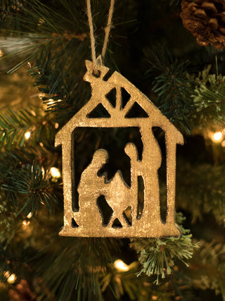 a wooden gold foil christmas tree ornament in the shape of the nativity perfect for christian holiday home decor and gifts