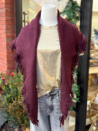 a wool wine colored triangle wrap layered over a gold top