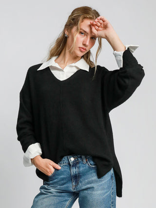 a relaxed fit black v neck knitted sweater with cut edge details