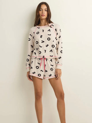 wear this long sleeve ivory sleep shirt with love letters as a pattern and pink trim for valentines with matching shorts