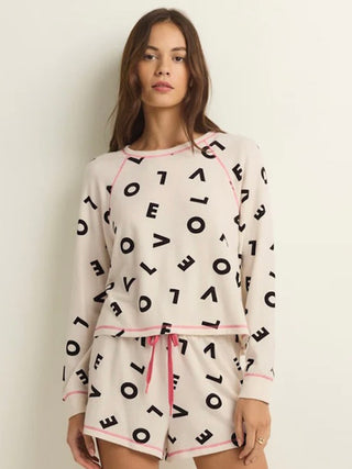 wear this long sleeve ivory sleep shirt with love letters as a pattern and pink trim for valentines with matching shorts