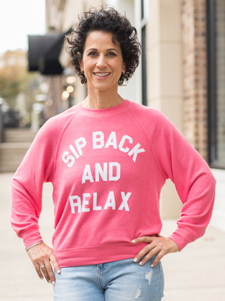 wear this bright coral sweatshirt with a witty wine saying as cozy loungewear and on holiday weekends