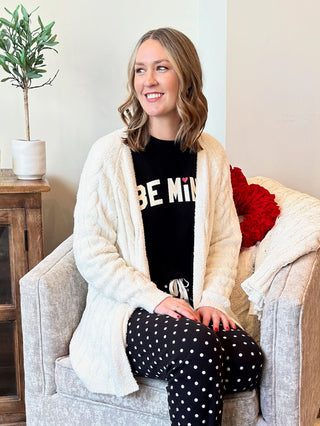 a soft warm cable knit cardigan sweater in a cream color