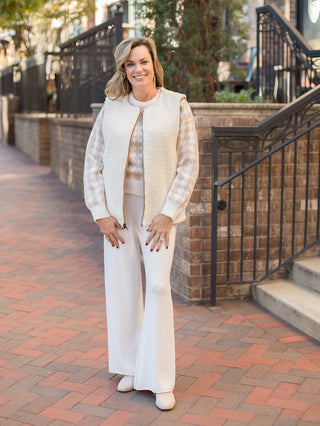 wear this classic white and beige sweater with houndstooth patterns to thanksgiving dinner with white bellbottoms