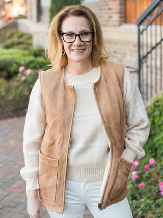 a light brown suede vest with quilt detailing and sherpa fabric inside for cozy seventies vibes great for winter wear