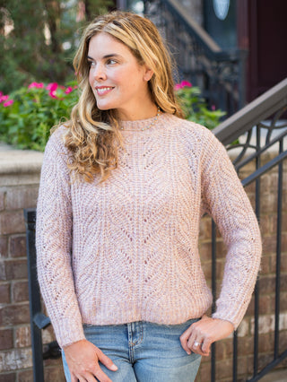 a pale pink cable stitch sweater in a relaxed fit perfect for cozy fall fashion