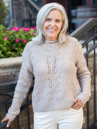 a cool beige cable stitch sweater in a relaxed fit perfect for cozy fall fashion