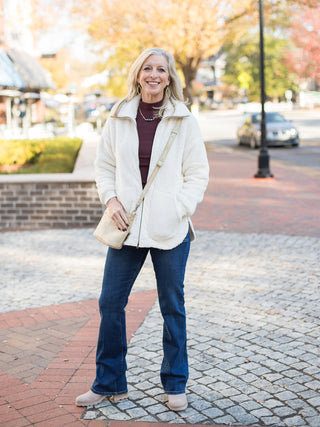 wear this oversized off white active jacket with a front zipper for everyday errands and cozy winter days with dark denim