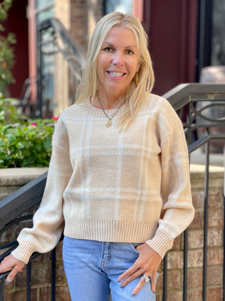 a tan long sleeve crew neck sweater with white plaid details perfect for sweater weather fashion