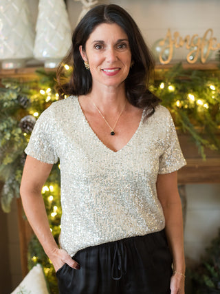 wear this flattering silver sequined short sleeve top for a glamorous vibe at holiday parties and christmas events