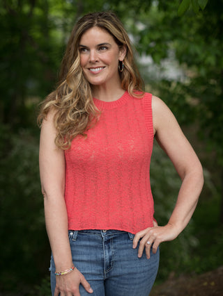 lightweight red sweater tank made of thin rib knit material is sleeveless with a round neck and rests just below the hip bone