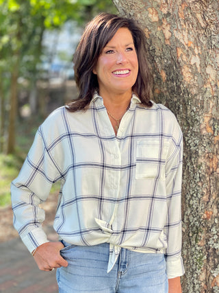 a long sleeve ivory button down blouse with navy blue plaid details perfect for farmhouse chic and relaxed holiday fashion