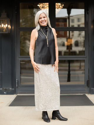 wear this silver sequined skirt for a glamorous vibe at holiday parties and christmas events with a black silk halter top
