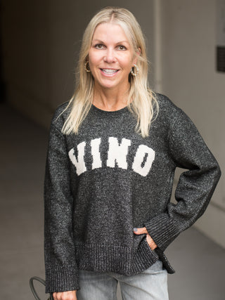 a dark grey oversize sweatshirt with vino written across in white perfect for fall fashion and wine lover gifts