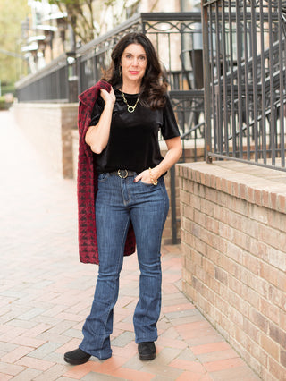 wear this black velvet short sleeve top to holiday and christmas gatherings for a casual and cozy look shown with red coat