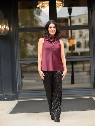 wear this pair of black sequined pants for a glamorous vibe at holiday parties and christmas events with a silk halter top