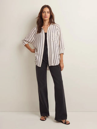 sophisticated cream and black striped button front shirt paired with black jeans