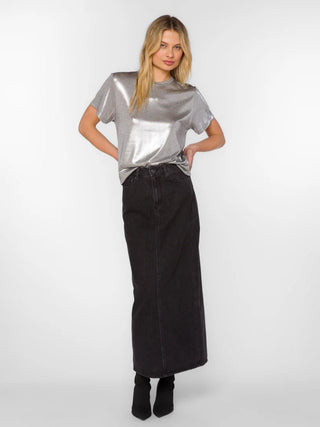 a shimmering metallic silver short sleeve crewneck top worn with a black skirt