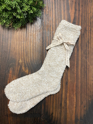 a pair of fuzzy off white socks great for loungewear and cold weather cozy fashion and christmas gifts