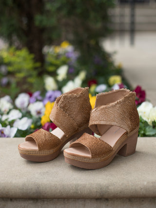 supremely comfortable tan high ankle heeled sandal with textured leather straps in asymmetrical design for edgy look