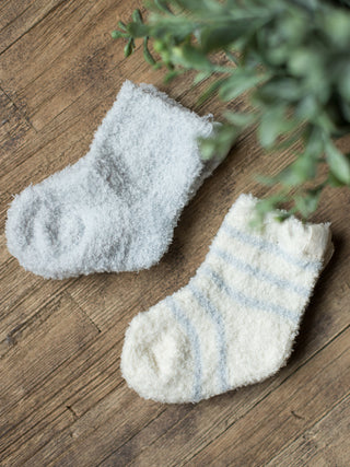 two pairs of blue plush baby socks featuring a heather pattern on one and stripes on the other