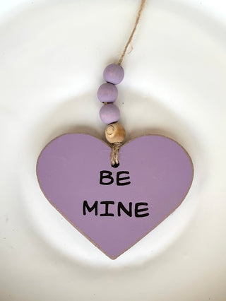 decorate your home or car with this lavender heart shaped ornament wth wooden beads that reads be mine for valentines day