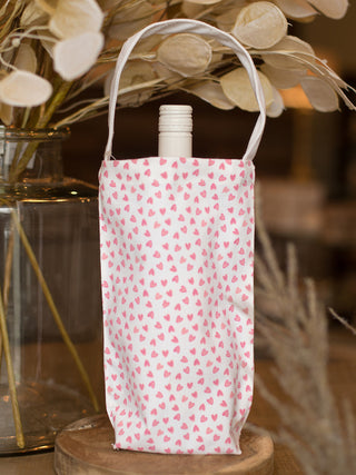 bring a gifted bottle of wine in this pink heart patterned canvas tote for valentines and galentines day gifts