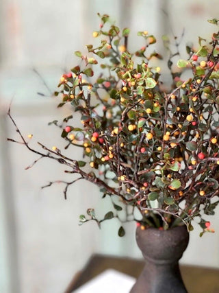 a bouquet of faux bush with red and yellow berries perfect for thanksgiving fall home decor