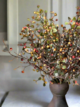 a bouquet of faux bush with red and yellow berries perfect for thanksgiving fall home decor
