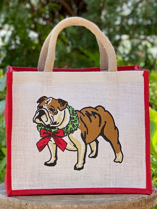 a white and red christmas jute tote bag with a georgia bulldog on the front perfect for uga fans holiday gifts