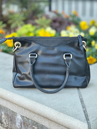 Casual Friday Bag - Black Adjustable crossbody strap included Exterior handles Zipper closure Two open exterior pockets suede trim Two open interior pockets One zipper interior pocket Bronze hardware Joy Susan L8093-00