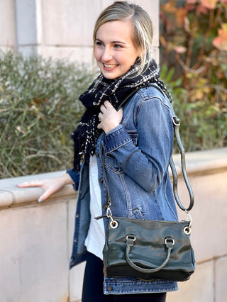 Casual Friday Bag - Olive Adjustable crossbody strap included Exterior handles Zipper closure Two open exterior pockets suede trim Two open interior pockets One zipper interior pocket Bronze hardware Joy Susan L8093-03