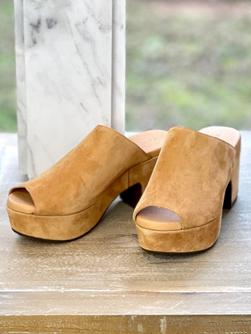 a pair of peep toe platform clogs in tan suede